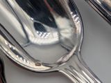 two spoons and a spoon rest on a table