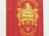 un livre rouge posé sur une table, à côté d'une table blanche