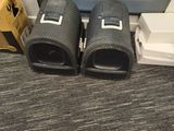 two speakers sitting next to each other on the floor