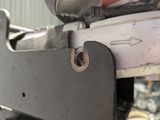 a close up of a metal object with a person working on it