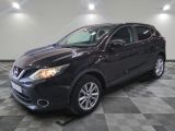 the black nissan qx is parked on a checkered tile floor