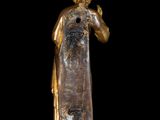 a gold statue of a man with a beard and a robe