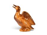 a brown bird that is sitting on a white surface
