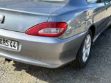 a silver car that is parked on the side of the road