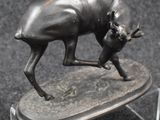 a statue of a bull that is standing on a base