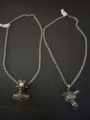 a couple of necklaces that are sitting on top of a table