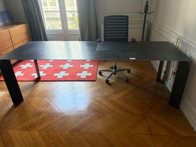 an image of a desk in a room with a red rug