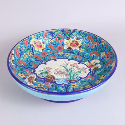 a blue bowl with a floral design on it