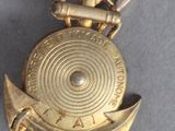an image of a gold medal with a sword and shield on it