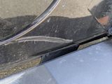 a close up of a car ' s front bumper with a mirror on it