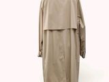 trench coat on a mannequin stand on a white background
