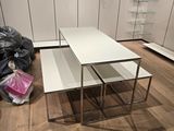 two tables that are sitting on the floor in the room