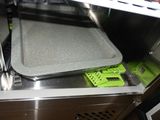 two trays in the bottom of a stainless steel dishwasher