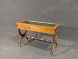 a wooden table with a glass top on a gray surface