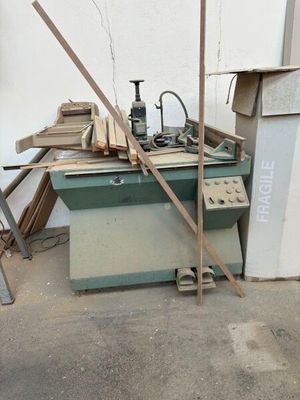 a machine that is sitting in the middle of a pile of wood
