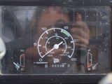 a close up of a motorcycle dashboard with a person taking a picture