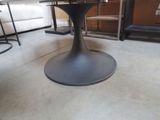 a black table with a glass top in a room