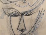 dessin représentant le visage d'une femme sur une feuille de papier