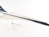 a model of a plane on a stand on a white surface