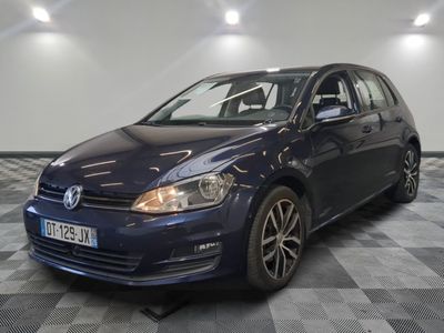 the blue volkswagen golf is parked on a checkered floor