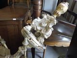 a statue that is sitting on a chair in a room