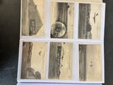 a stack of old postcards sitting on top of a table