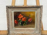 a picture of a painting on an easel with a vase of flowers on it