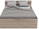 the bed frame is made of wood and has two pillows on it