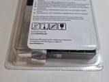 a plastic container with a pen in it sitting on a table