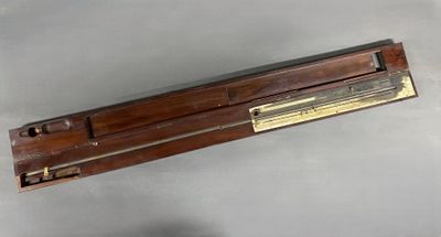 an old wooden box with a metal handle on a gray surface