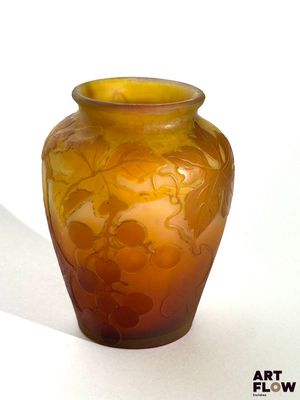 a glass vase with a flower design on it on a table
