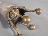 a close up of a metal object on a white surface