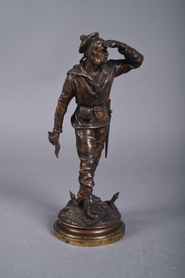 pair of bronze figurines of a man and a dog