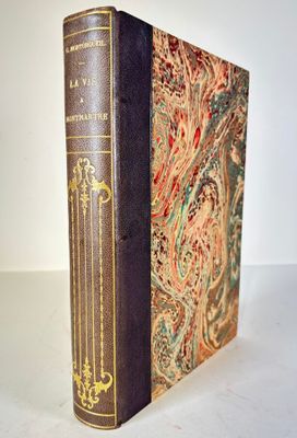 an old book sitting on top of a table next to a white wall