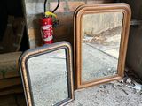 two mirrors sitting on the ground next to a fire hydrant