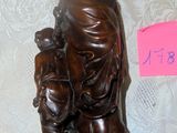 a statue of a woman holding a child on a table
