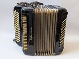 a black and gold accordion sitting on top of a white table