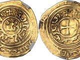 a close up of two gold coins on a white surface