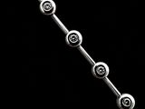 a close up of a silver bracelet on a black background