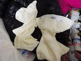 a pile of clothes that is sitting on a bed