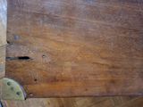a wooden table with a metal latch on it