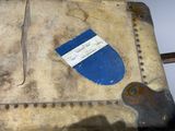 a piece of luggage sitting on a table with a tag on it