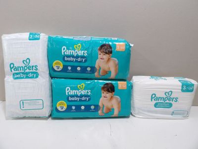 three packs of baby diapers sitting on top of each other
