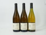 three bottles of wine sitting next to each other on a table