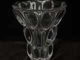 a glass vase that is sitting on a black cloth