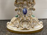 an image of a white and gold bowl with a blue stone in the center