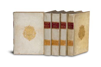 three books are lined up in a row on a white surface