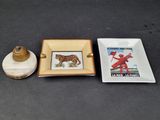 a small plate with a picture on it next to a small square plate with a picture on it