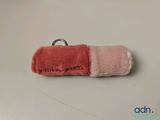 a pink and pink pen case with a ring on it