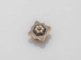 an 18k gold and diamond flower broochle